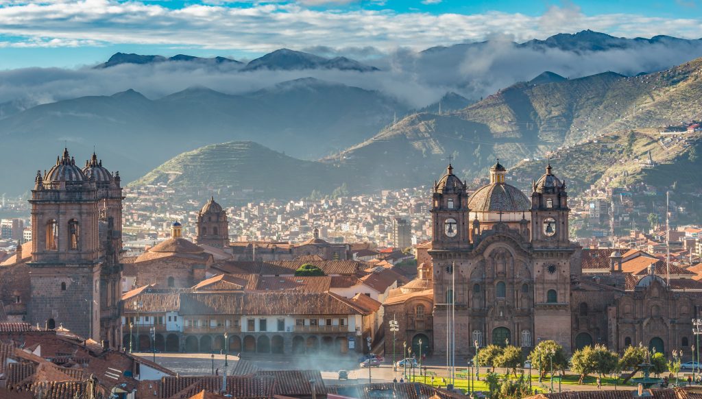 Morning sun rising at Plaza de armas with Adean Moutain and group of cloud, Cusco, Peru