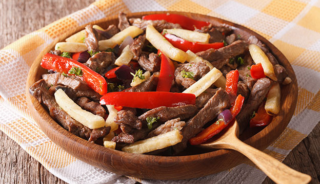 Homemade Peruvian Food: Lomo saltado close-up on a plate. Horizontal