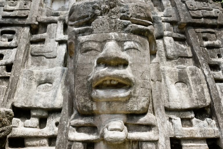 Ancient face in stone in ruin.