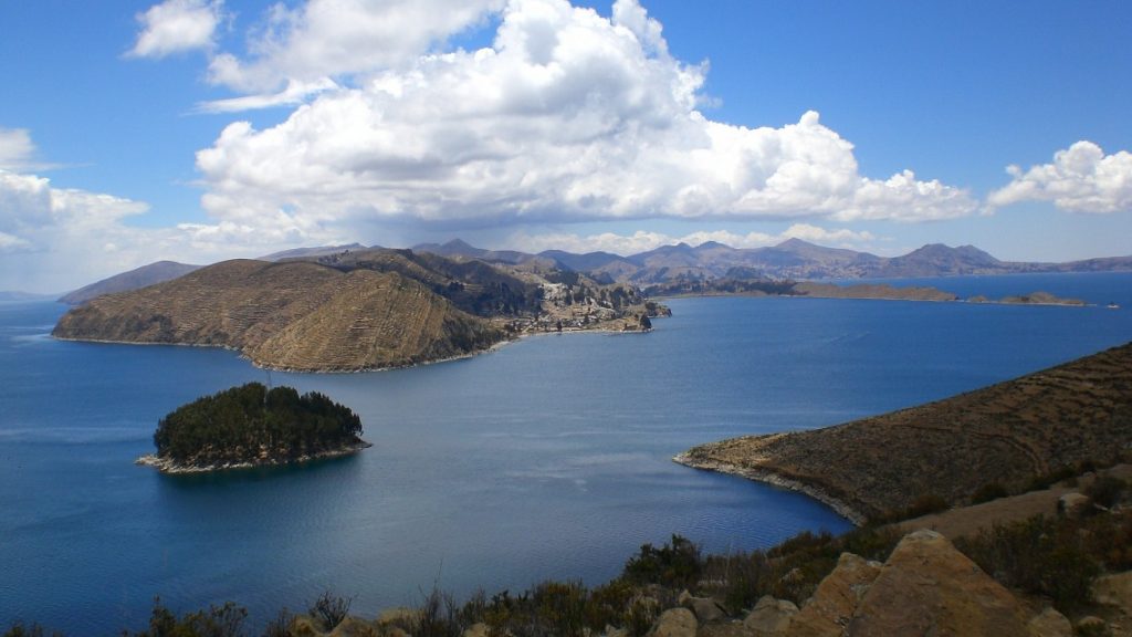 aerial view over lake with green island